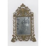 French cast brass mirror, rectangular bevelled glass plated surmounted with a mask and cherubs and