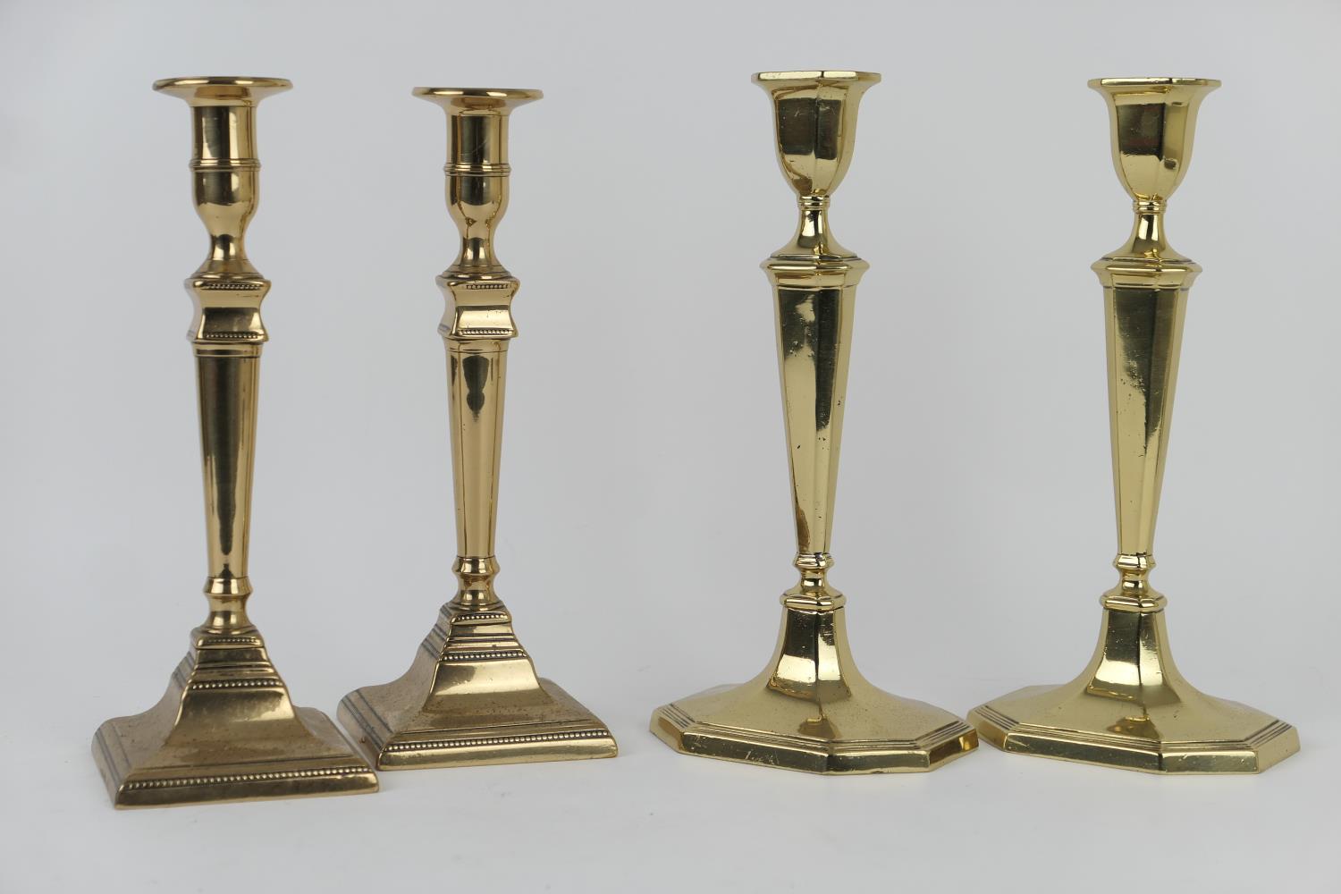 Two pairs of 19th Century brass candlesticks, one pair marked 'WT&S', 28cm and 27cm