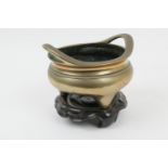 Chinese polished brass censer, seal marked to the base, 7cm, raised on carved wooden stand