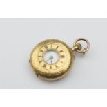 18ct gold lady's half hunter fob watch, the cover with foliate engraving and black enamelled Roman