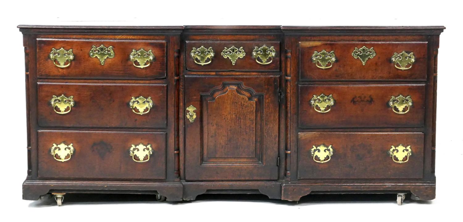 George II oak inverted breakfront dresser, circa 1730-50, two plank top over a central short