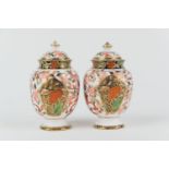 Matched pair of Crown Derby Porcelain imari lidded vases, circa 1878-1887, ovoid form with domed