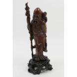 Finely carved Chinese wooden figure of Lohan, height 19cm, mounted on a carved wooden stand, total