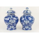 Pair of Chinese blue and white prunus pattern lidded jars, late 19th Century, of inverted baluster