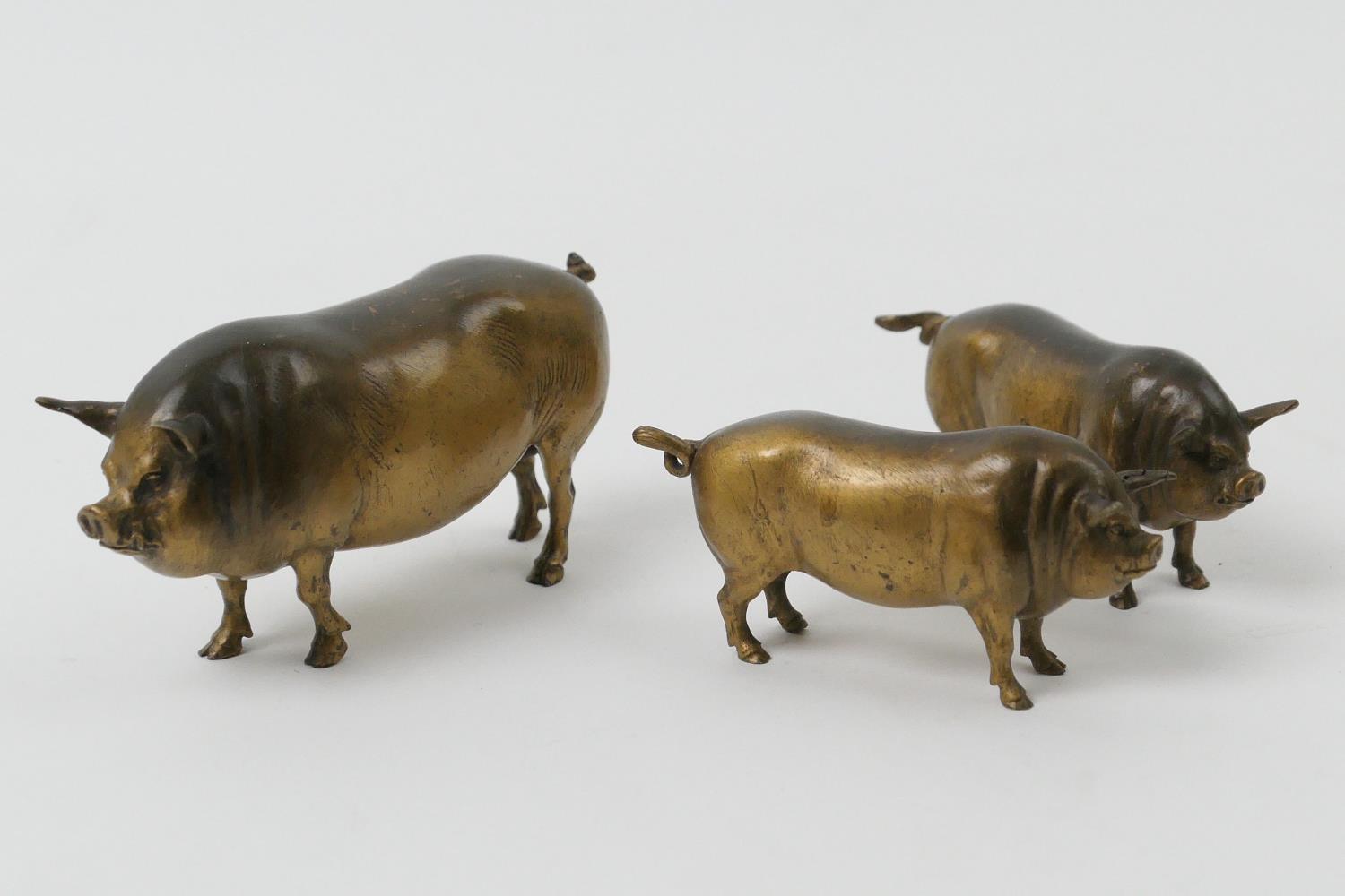 Austrian cold painted bronze pot bellied pig, circa 1900, height 7cm; also two similar, smaller