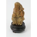 Chinese soapstone carving of Shoulao, late 19th or early 20th Century, 10.5cm, mounted on a wooden