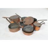 A number of copper pans, and three copper saucepan lids, both English and Continental, the largest