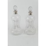 Pair of silver mounted clear glass kluk-kluk decanters, with stoppers, hallmarked Birmingham 1936,