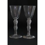 Pair of air twist wine glasses, each with round funnel bowl over double knot spiral air twist stem