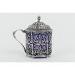 French silver wet mustard pot, circa 1900, pierced throughout with scrolling foliage, centred with