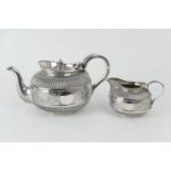 Victorian silver teapot and matching milk jug, by Martin Hall & Co., London 1888, bun form with a