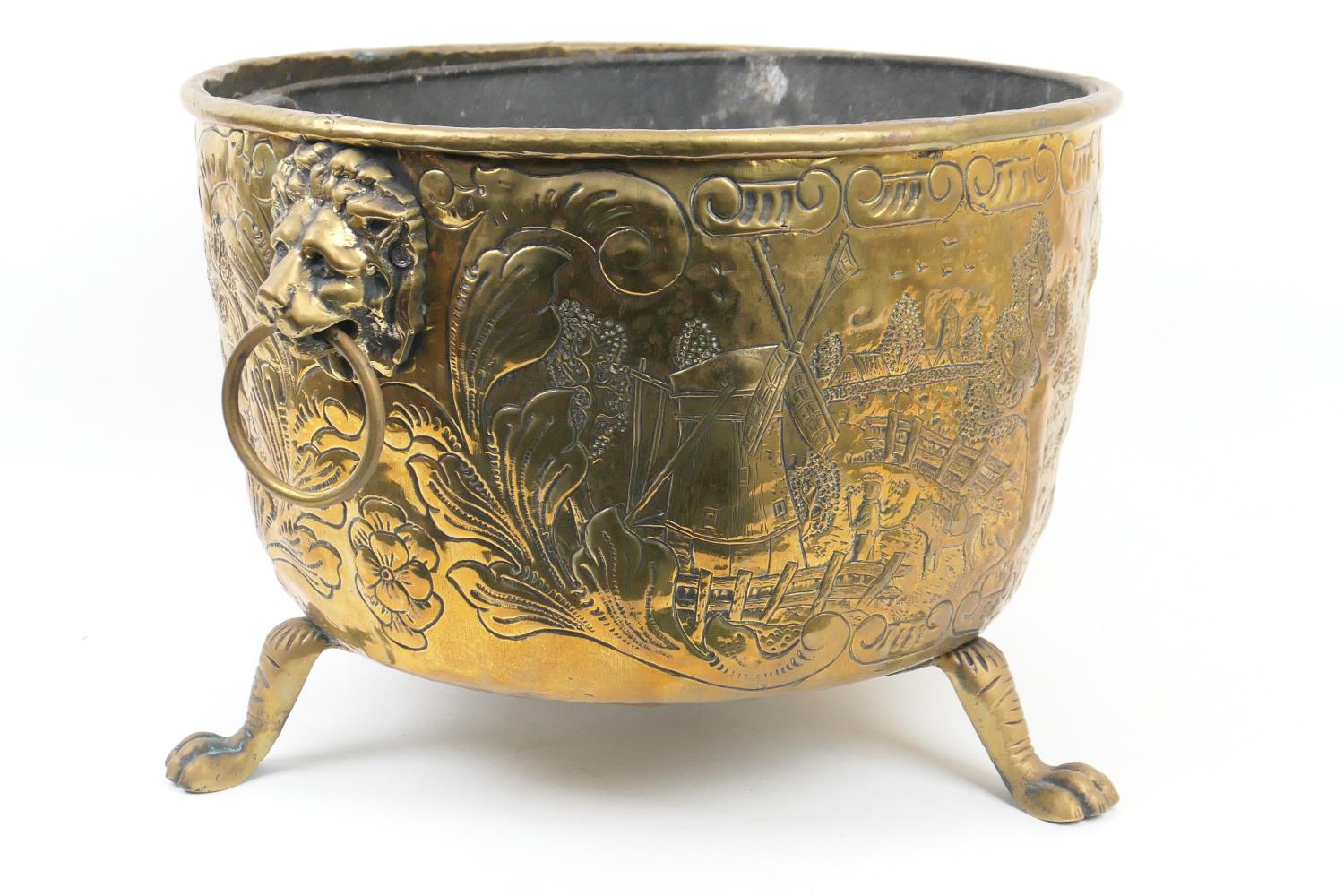 Dutch brass log bin, having lion mask ring handles, embossed with hunting scenes and foliate