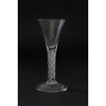 Late George II wine glass, circa 1750, drawn trumpet bowl over seven ply spiral band encasing a