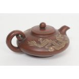 Chinese Yixing teapot, squat form carved with scrolling dragons, the base with a Zhuanshu seal mark,