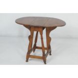 American Colonial tiger and curly maple small drop leaf table, early 19th Century, the oval top with