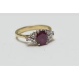 Ruby and diamond cluster ring, in 18ct white and yellow gold, centred with an oval cut ruby of