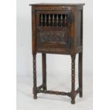 Oak joined food cupboard, or aumbry (made up), having a door with carved panel and spindles, opening