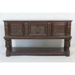 Carved oak sideboard in Elizabethan style, centred with two carved recessed panel drawers flanked by