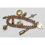 9ct gold curb link charm bracelet, with padlock clasp and safety chain, supporting a number of 9ct
