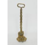 Victorian cast brass paw and feather door porter, height 37cm