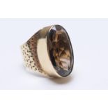9ct gold smoky quartz dress ring, the oval stone approx. 22mm x 11mm, in a high collet mount, size
