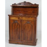 Early Victorian mahogany chiffonier, the back panel carved with a shell and paper scrolls, fitted