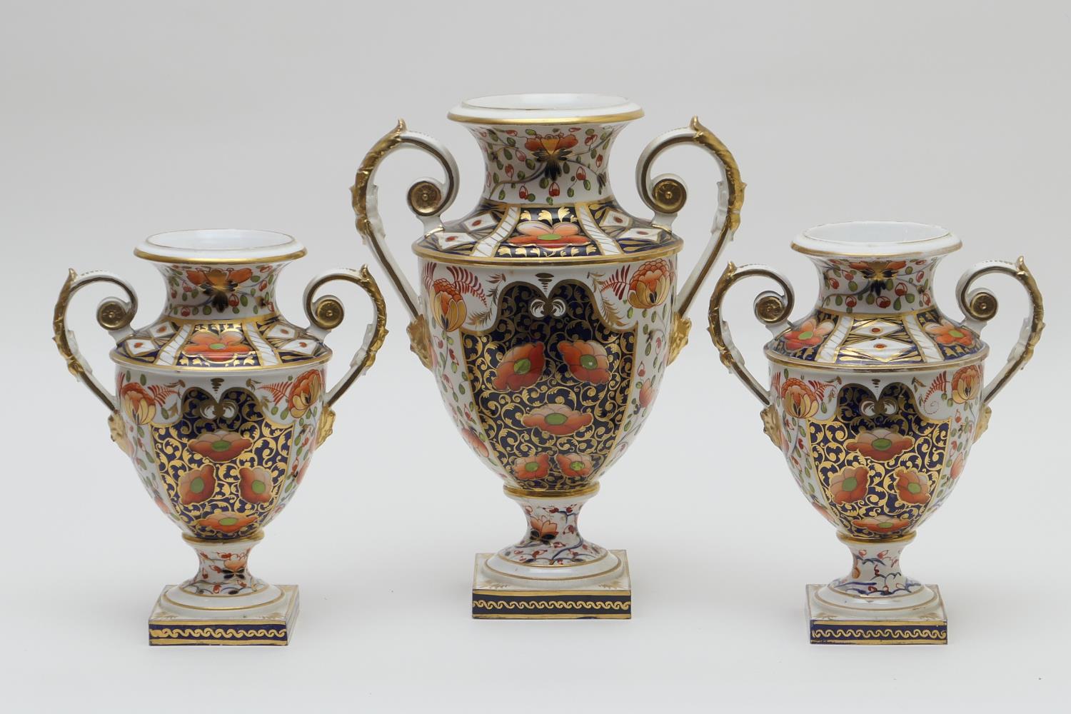 Derby imari porcelain garniture, circa 1800-25, each of twin handled urn shape, decorated in typical