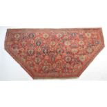 Ushak woollen rug, re-shaped to fit a bay window, red ground, 348cm x 180cm max.