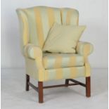 Modern upholstered wing armchair in Georgian style, finished in gold and green Regency stripe, width