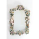 Sitzendorf porcelain dressing table mirror, arched rectangular form encrusted with a polychrome