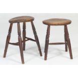 Two 19th Century elm seated stools, each with turned legs, one 49cm, the other 44cm, the seats