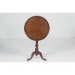 Mahogany dish topped tripod table, the circular tilting top over a turned urn column with three