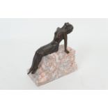 French bronze figure in the Art Deco style, cast as a woman leaning back over a scagliola marble