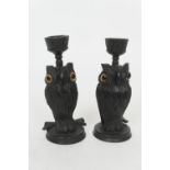 Pair of novelty carved ebony pricket candlestands, worked as owls, with glass eyes, 11.5cm