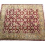 Frith style woollen Agra carpet, red field with large palmettes within a gold palmette border,