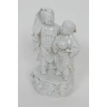 Chinese blanc de chine figure group, late 19th Century, modelled as two boys, one supporting a