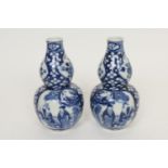 Pair of Chinese blue and white gourd vases, late 19th Century, decorated with figural panels against