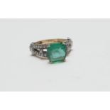 Emerald and diamond cluster ring in 9ct gold, having a cushion cut emerald of approx. 3cts, in a