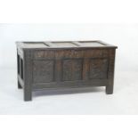 Oak joined coffer, late 17th Century, having a three recessed panel hinged top over a carved