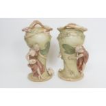 Pair of Royal Dux Art Nouveau style figural vases, each modelled with a maiden feeding doves, in