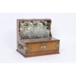 Victorian oak and brass mounted tantalus, supporting three hobnail cut glass spirit decanters over a