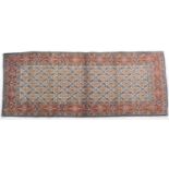 Moud woollen rug, fawn field dispersed with a myriad of blue flowerheads, within a terracotta