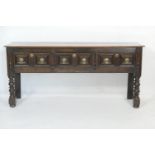 Oak low dresser, circa 1700 and later, having three moulded panel drawers with brass drop handles,