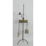 Dutch style wrought iron and brass fire side companion, with a metal bracket supporting a candle