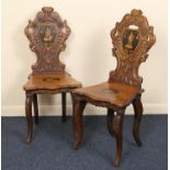 Pair of Tyrolean carved walnut and inlaid hall chairs, late 19th Century, shaped carved backs