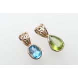 Two semi-precious gem set pendants, being a pear cut peridot and a blue topaz, both set in