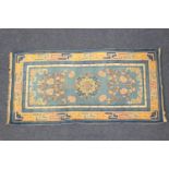 Peking blue ground woollen rug, blue field dispersed with trellis and peony, within a geometric