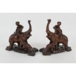 Pair of Chinese carved wooden figures of boys on the back of an elephant, with a calf in attendance,