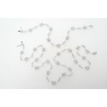 Diamond necklace and matching bracelet, in 18ct white gold, the necklace having flowerheads set with