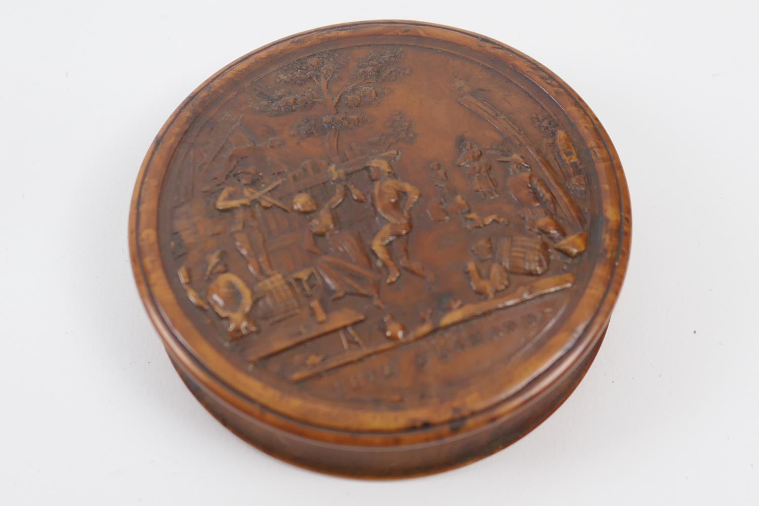 Pressed burr wood circular snuff box, 19th Century, the cover decorated with a scene of revellers,